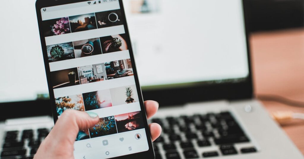 A person uses a smartphone to browse social media in front of a laptop, emphasizing modern technology and lifestyle.